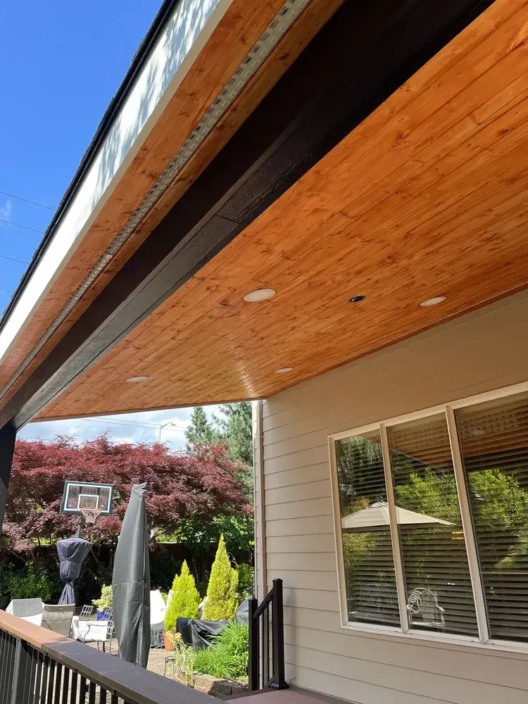 Cedar tongue-and-groove ceiling with recessed lights set into a new deck cover