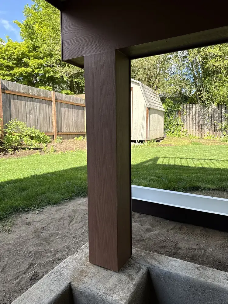 Wrapped support post carrying a new deck cover, looking out across the back lawn