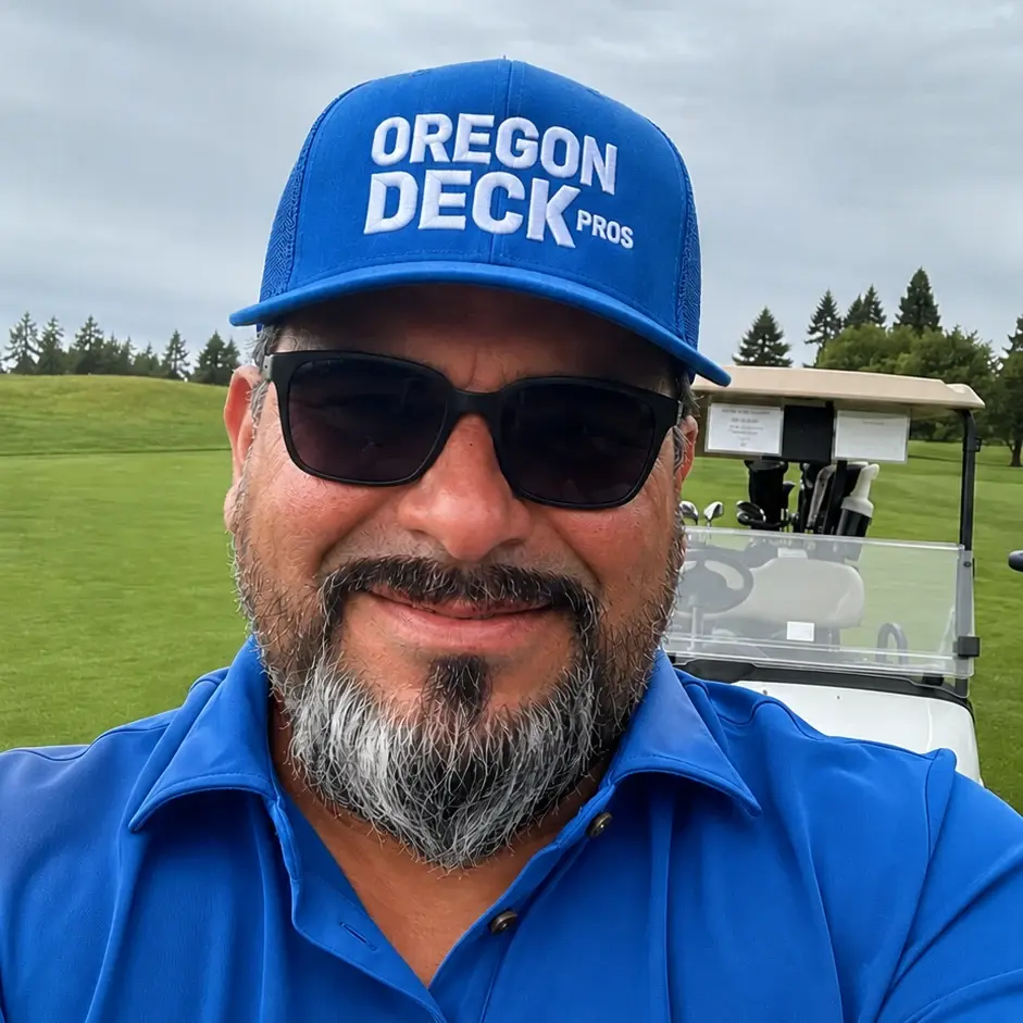 Edgar, owner of Oregon Deck Pros, wearing a company cap