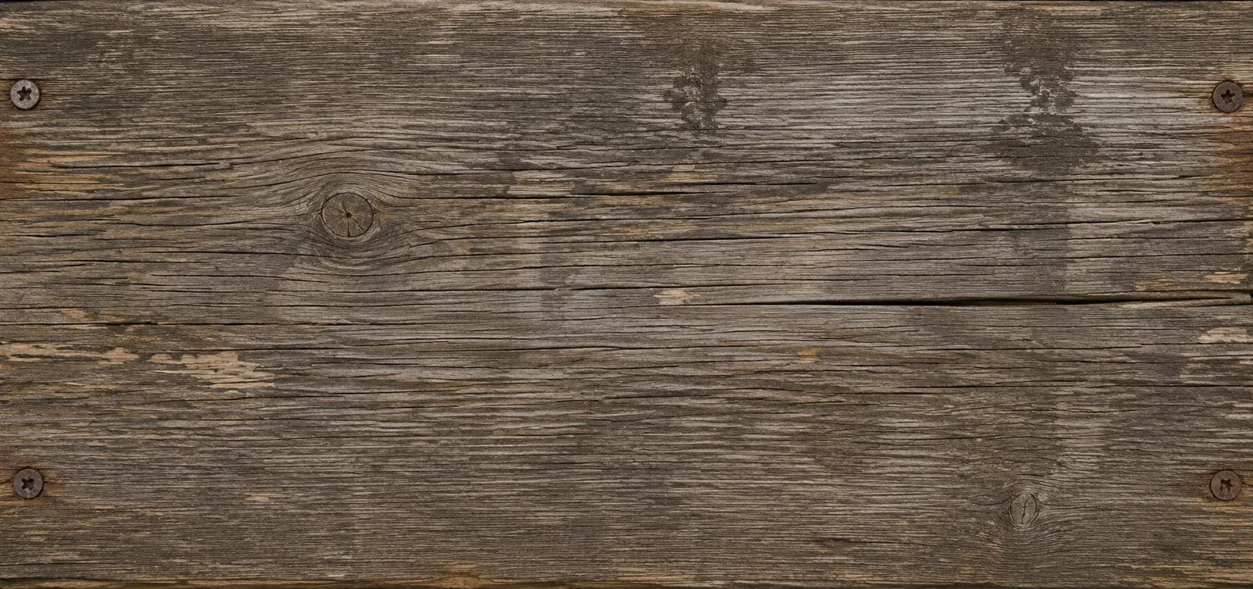 Weathered wood deck boards with visible grain, splits, and rusted screw heads